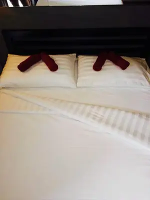two red mittens sitting on top of a bed at Popcorn House Ratchada in Bangkok
