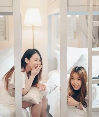 two young girls sitting in a bunk bed at Noursabah Boutique Bed Bangkok in Bangkok