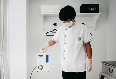 a chef in a kitchen holding a box at Noursabah Boutique Bed Bangkok in Bangkok