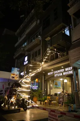 a motorcycle parked in front of a building at night at BoB Hostel บ็อบโฮสเทล in Bangkok