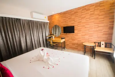 a bedroom with a bed with a swan on it at Villa Baron SHA PLUS in Nonthaburi