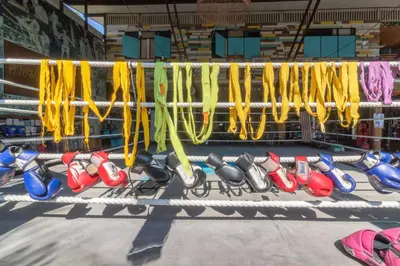 a row ofboxing racks in a boxing ring at Sor Vorapin Muay Thai Home in Bangkok