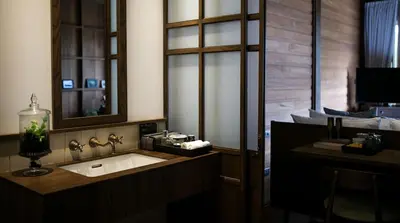 a bathroom with a sink and a mirror at Chann Bangkok Noi in Bangkok
