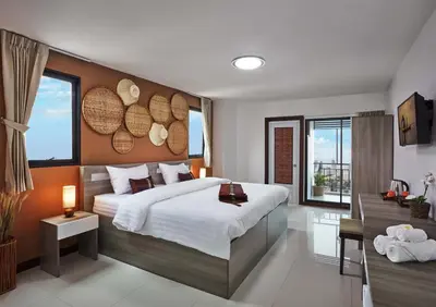 a bedroom with a large bed and a large window at Baan Thai Boutique in Bangkok