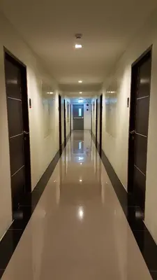 an empty hallway of a building with doors and ceilings at The Pixel Places in Nonthaburi