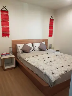 a bedroom with a large bed with red accents at Rich Park@Tao poon interchange in Bang Su