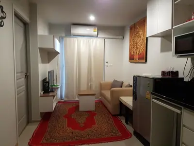 a small living room with a couch and a kitchen at Rich Park@Tao poon interchange in Bang Su