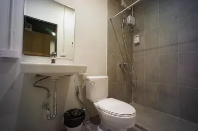 a bathroom with a toilet and a sink and a shower at BRB Hostel Bangkok Silom in Bangkok