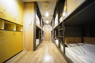 a corridor of a dorm room with bunk beds at BRB Hostel Bangkok Silom in Bangkok