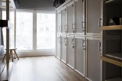a large kitchen with a large window and cabinets at Bed One Block Hostel in Bangkok