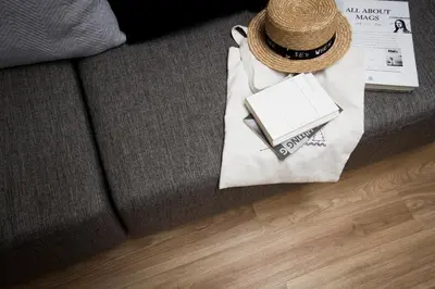 a straw hat and a bag on a couch at Bed One Block Hostel in Bangkok