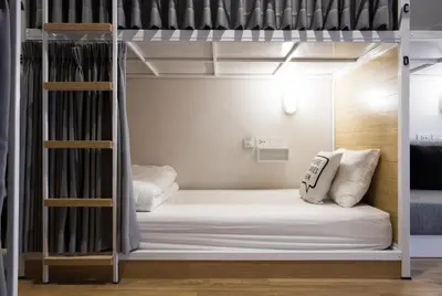a bedroom with bunk beds in a room at Bed One Block Hostel in Bangkok