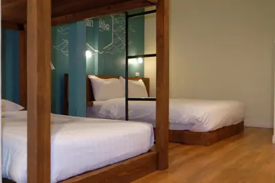 a bedroom with two bunk beds and a mirror at Siri Poshtel Bangkok in Bangkok