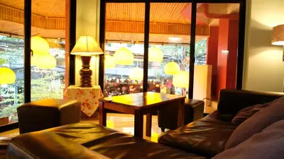 a living room with a couch and a table at Villa Cha-Cha Khaosan Rambuttri in Bangkok