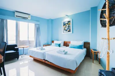 a bedroom with a large bed with blue walls at Villa Cha-Cha Khaosan Rambuttri in Bangkok