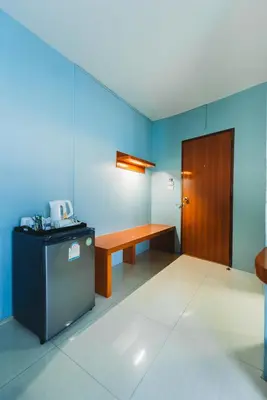 a room with a table and a bench and a door at Villa Cha-Cha Khaosan Rambuttri in Bangkok