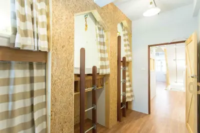 a room with a kitchen with a counter top at Barn & Bed Hostel in Bangkok