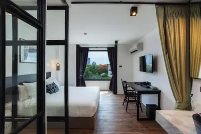 a hotel room with a bed and a desk at Oriental Heritage Hotel in Bangkok