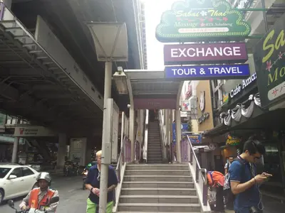 a group of people walking down a street with stairs at Pula Silom in Bangkok