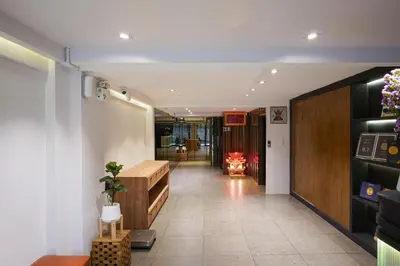 a room with a hallway with a table and a fireplace at Marwin Space in Bangkok