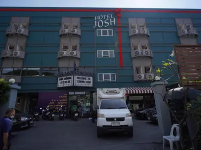 a white truck parked in front of a building at Josh Hotel in Bangkok