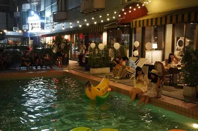 a pool with a banana boat in the water at Josh Hotel in Bangkok