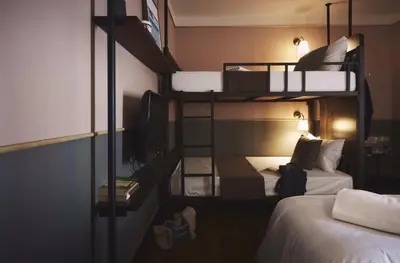 a room with two bunk beds and a bed at Josh Hotel in Bangkok