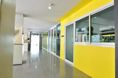 a hallway with yellow and white walls in a building at A18 in Nonthaburi