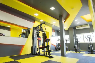 a gym with several tread machines in a room at A18 in Nonthaburi