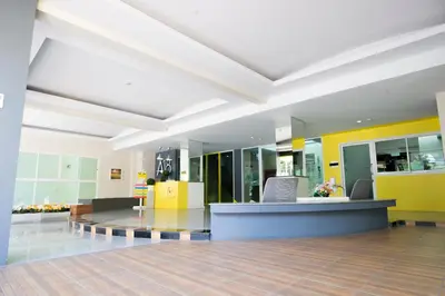 a lobby of a hospital with yellow and white walls at A18 in Nonthaburi
