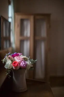 a vase filled with flowers sitting on a table at Vera Nidhra - Self check-in after 6pm in Bangkok