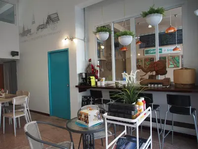 a restaurant with a table with a cake on it at Sriyanar Place in Bangkok