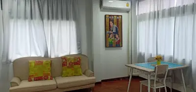 a living room with a couch and a table at Sriyanar Place in Bangkok