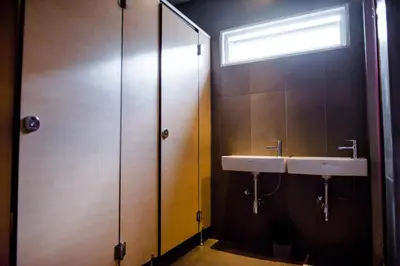 a bathroom with a sink and a shower at GN Luxury Hostel in Bangkok
