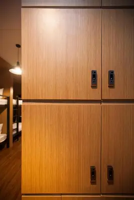 a row of wooden lockers in a room at GN Luxury Hostel in Bangkok