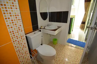 a bathroom with a toilet and a sink at The Best Place in Samutprakarn