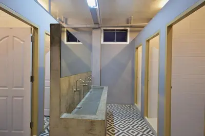 a bathroom with a bath tub and a sink at Inn Stations Hostel in Bangkok