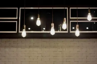a row of light bulbs hanging from a bar at Inn Stations Hostel in Bangkok