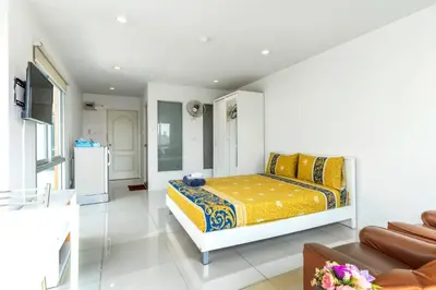 a bedroom with a bed and a couch at Right Place Sathorn in Bangkok