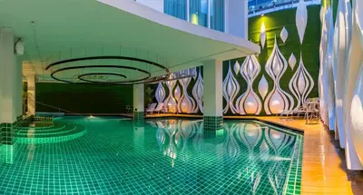 a swimming pool in the middle of a building at Anajak Bangkok Hotel - SHA Plus in Bangkok