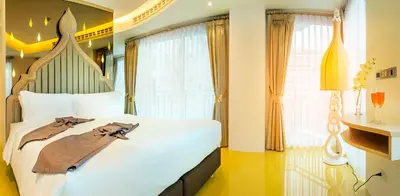 a bedroom with a large white bed with a large window at Anajak Bangkok Hotel - SHA Plus in Bangkok