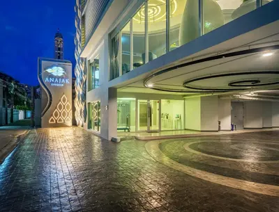 an empty street in front of a building at night at Anajak Bangkok Hotel - SHA Plus in Bangkok