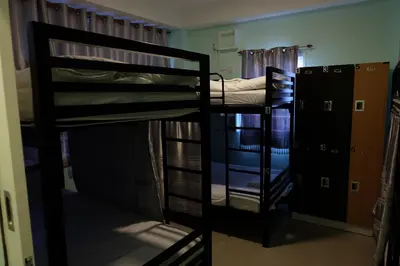 a room with two bunk beds in a dorm room at Mahannop Hostel in Bangkok