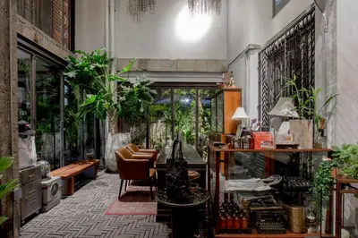 a room filled with lots of plants and a table at IR-ON Hotel in Bangkok