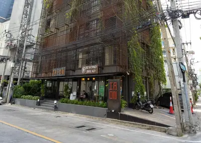 a building with a store on the side of a street at IR-ON Hotel in Bangkok