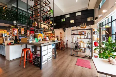 a kitchen with a counter with stools in a room at BB House Khlong Tan บีบีเฮ้าส์ คลองตัน in Bangkok