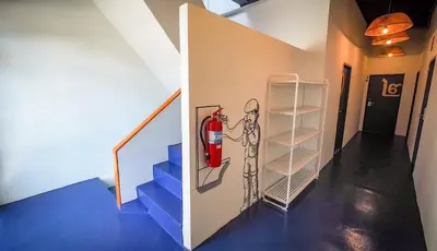 a staircase with a fire hydrant on the wall at Hoft Hostel Bangkok in Bangkok
