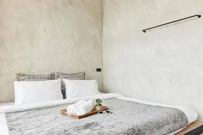 a bedroom with a large bed with a tray on it at Vann Bangkok Boutique House in Bangkok