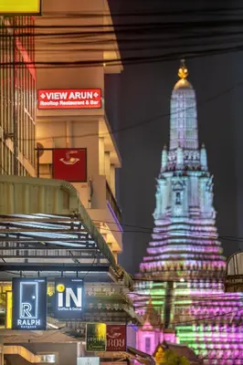 a building with a lit up tower in the background at RALPH Bangkok in Bangkok
