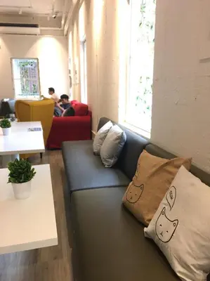 a couch in a room with pillows on it at Norn Yaowarat Hotel in Bangkok